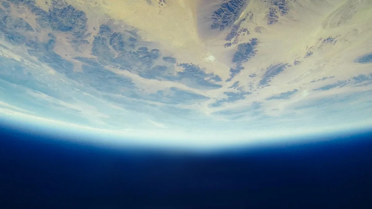 A satellite view of Earth showing varying atmospheric haze and color shifts.