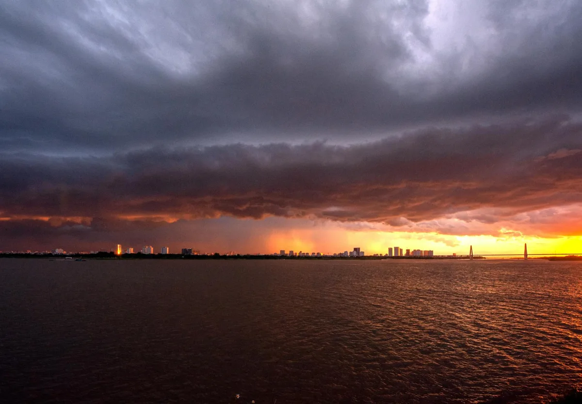 Storm clouds gathering over a coastal horizon, late afternoon light.