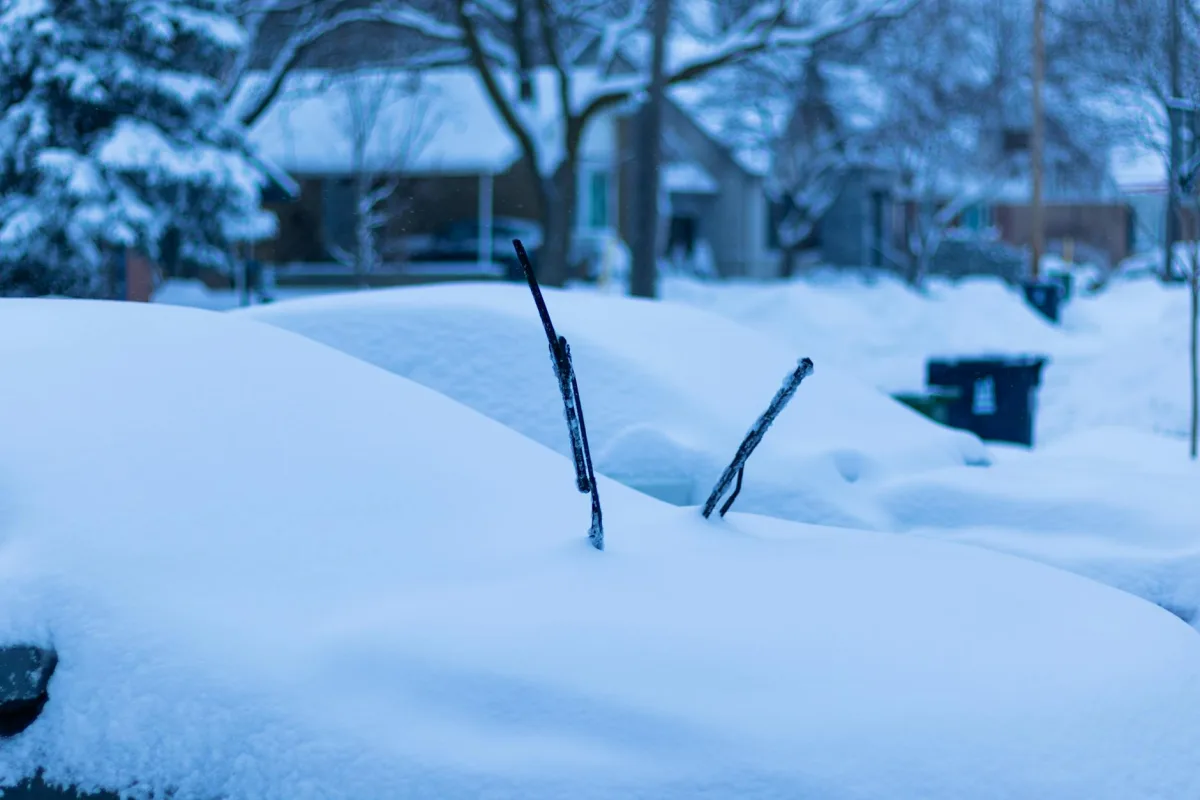 A snow-covered residential street with crisp, clear air above.